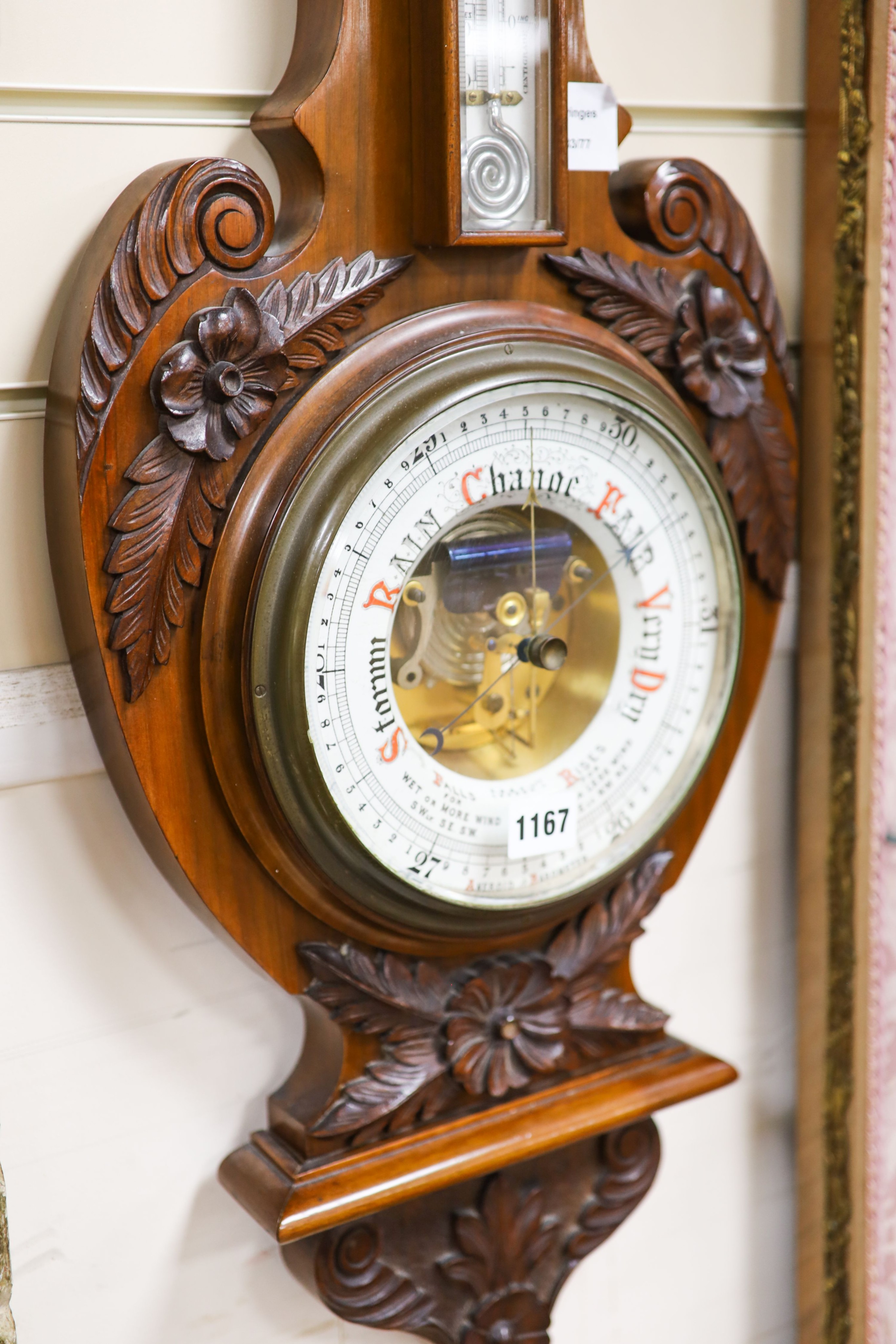 An Edwardian carved walnut cased aneroid barometer and thermometer, height 99cm